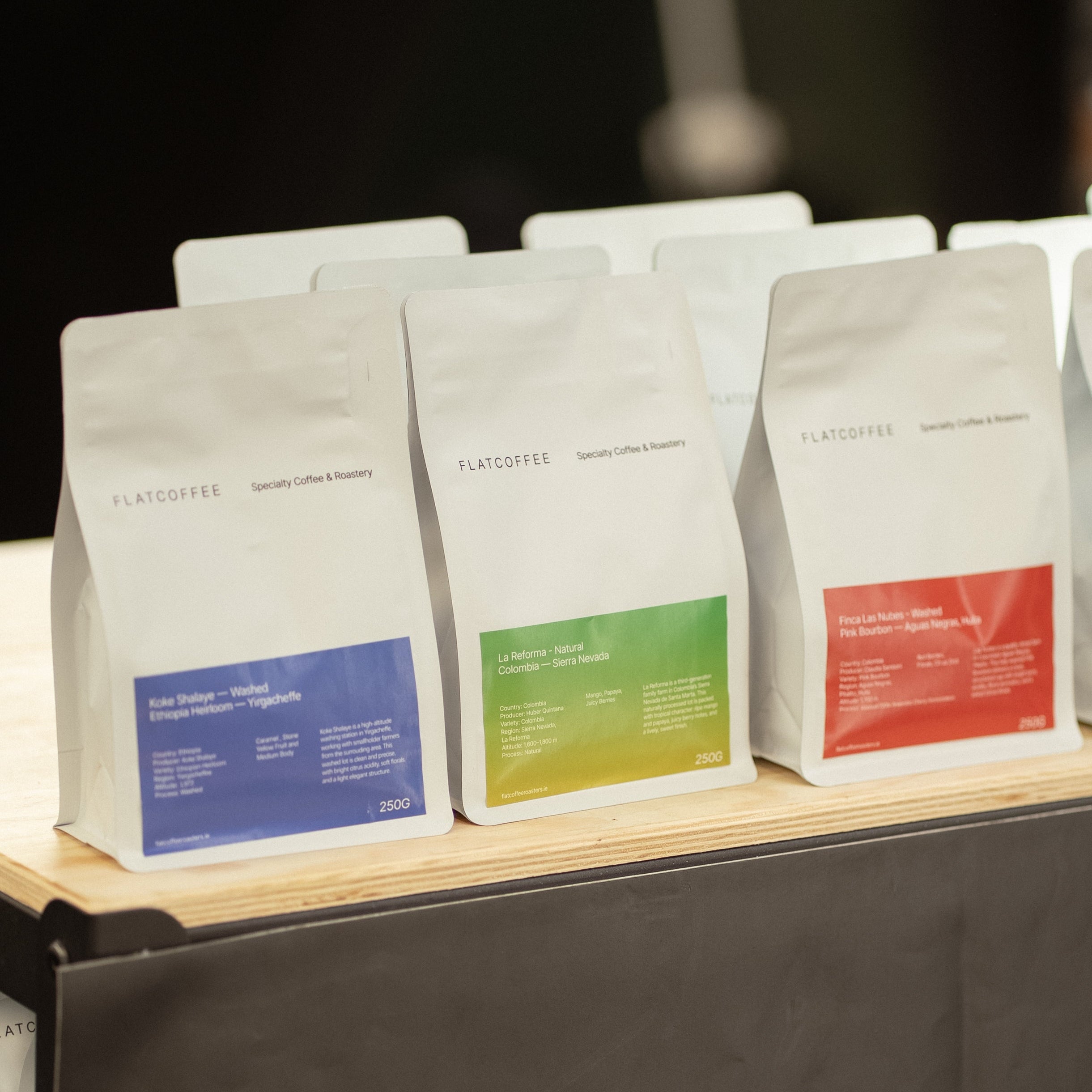 Flatcoffee specialty coffee beans display on shelf, Colombia, Ethiopia and Brazil single origin bags